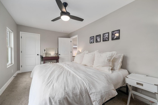 bedroom with a ceiling fan, baseboards, and carpet