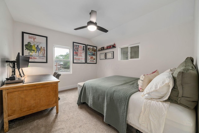 bedroom featuring baseboards, a ceiling fan, lofted ceiling, and light carpet