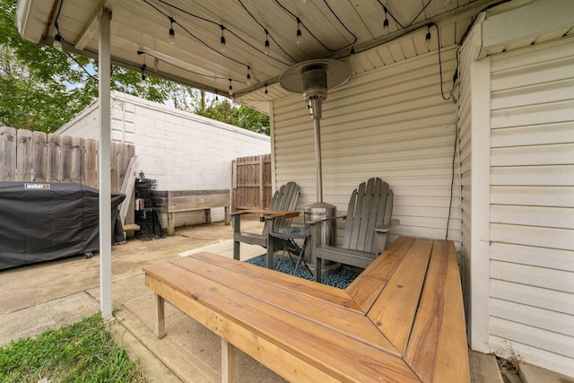 wooden deck with fence and a patio area