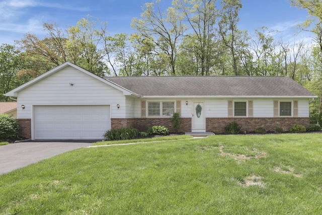 ranch-style home featuring brick siding, aphalt driveway, a front lawn, and a garage