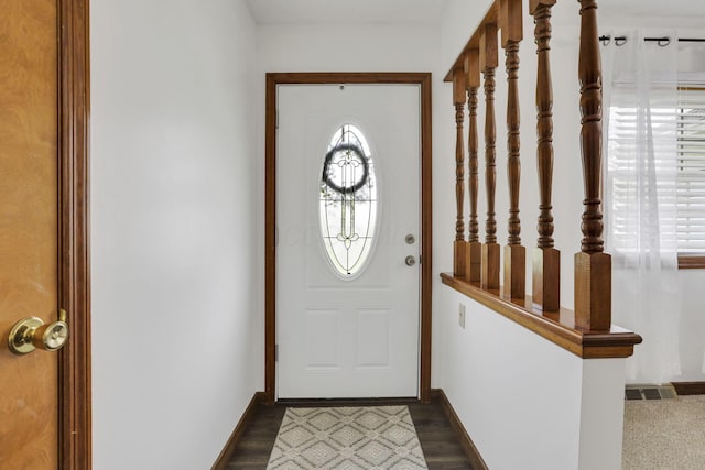doorway to outside featuring visible vents and baseboards