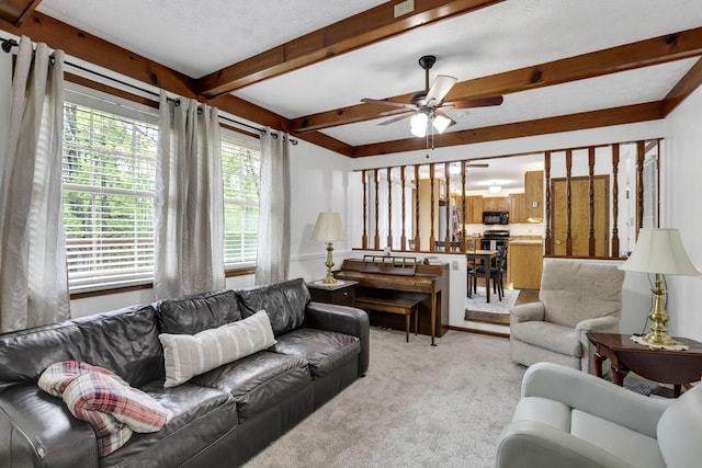living room with light colored carpet, a ceiling fan, and beam ceiling