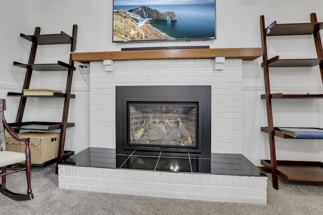 room details featuring carpet and a fireplace