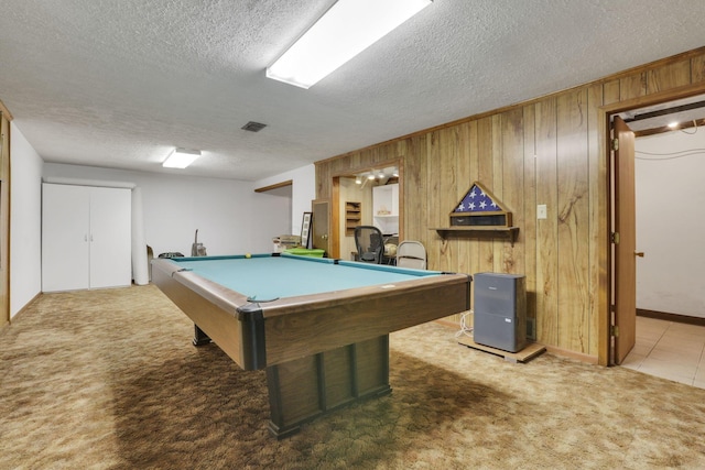 playroom with a textured ceiling, pool table, visible vents, wooden walls, and carpet floors