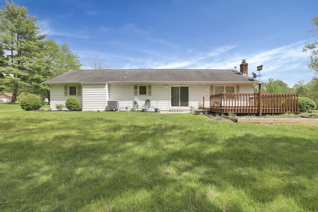 back of house with central air condition unit, a deck, a chimney, and a yard