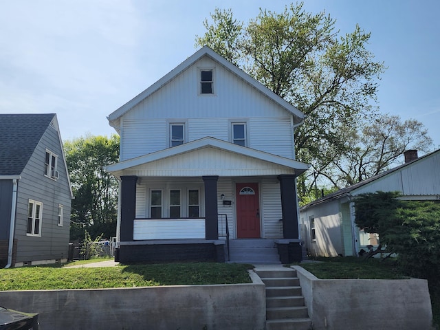 view of front facade featuring covered porch and a front lawn