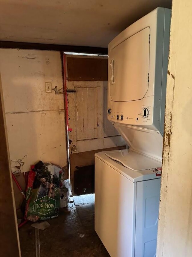 laundry area featuring stacked washer / drying machine and laundry area