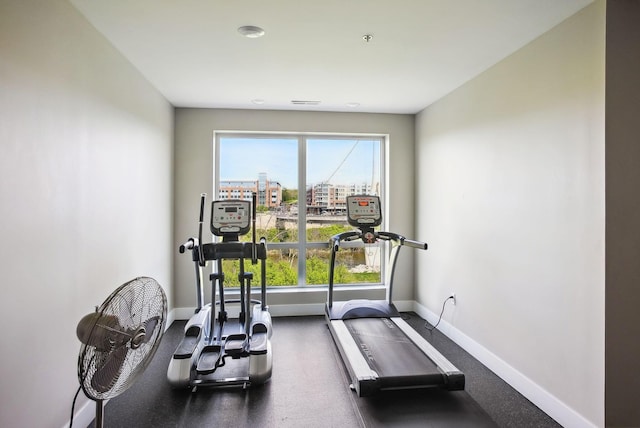 exercise room with baseboards and plenty of natural light