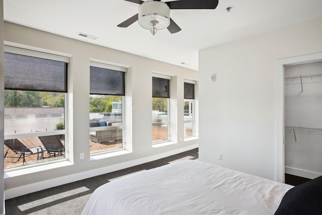 carpeted bedroom featuring baseboards, a closet, and a ceiling fan
