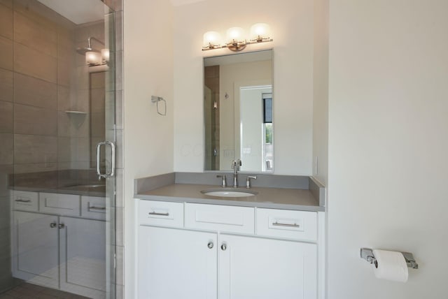 full bath with a shower stall and vanity