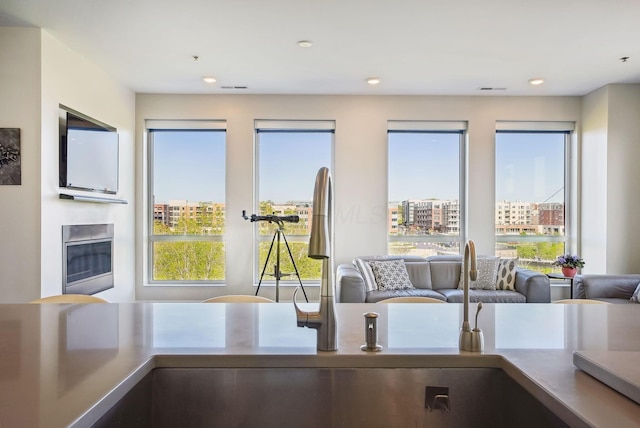 kitchen with open floor plan, a sink, recessed lighting, and a view of city