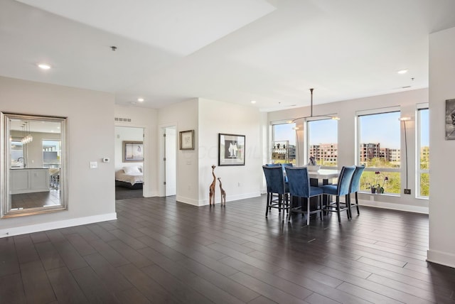 dining area featuring baseboards, recessed lighting, and dark wood finished floors