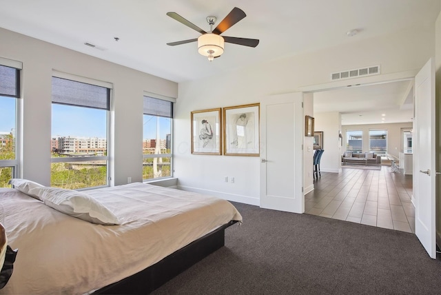 bedroom featuring carpet, a ceiling fan, and baseboards