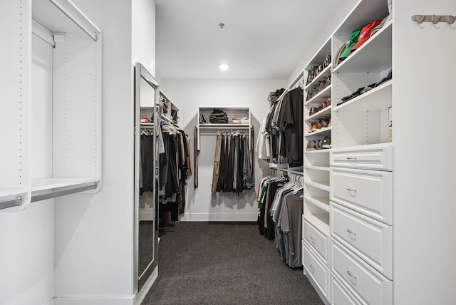 spacious closet featuring dark carpet