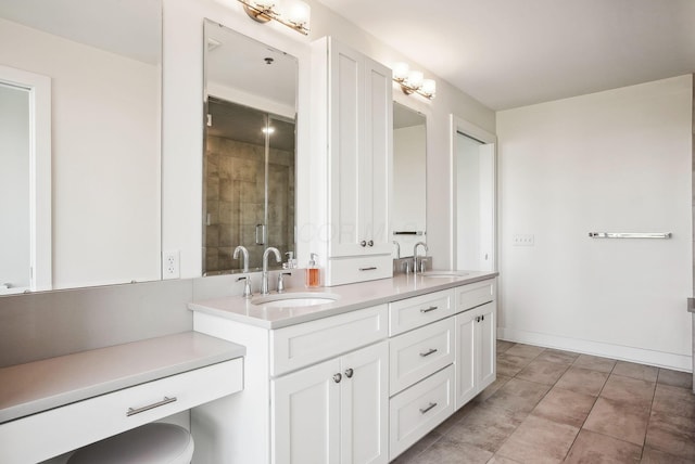bathroom with a shower stall and double vanity