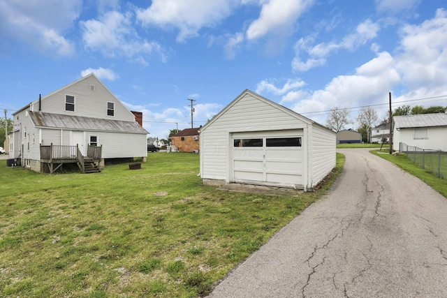 detached garage with asphalt driveway