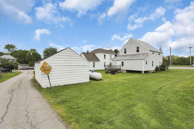 rear view of property featuring a lawn