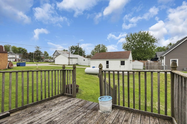 wooden deck with a lawn, a residential view, and an outbuilding