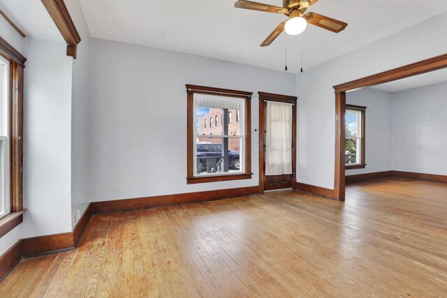 spare room with plenty of natural light, hardwood / wood-style floors, and baseboards