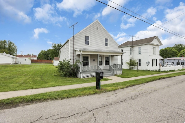 view of front of home with covered porch and a front yard