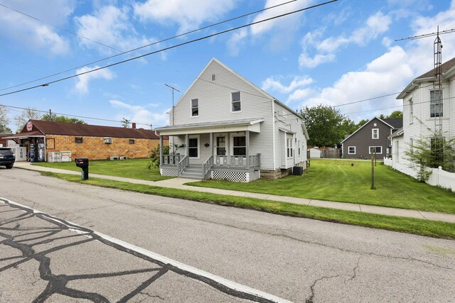 traditional home featuring a porch and central AC