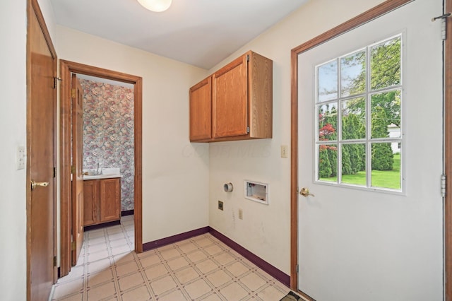 washroom featuring cabinet space, light flooring, washer hookup, hookup for an electric dryer, and baseboards