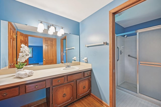 full bath featuring a stall shower and vanity