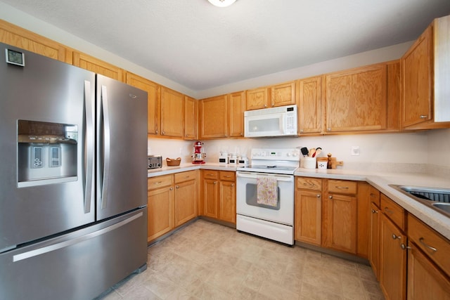 kitchen with white appliances and light countertops