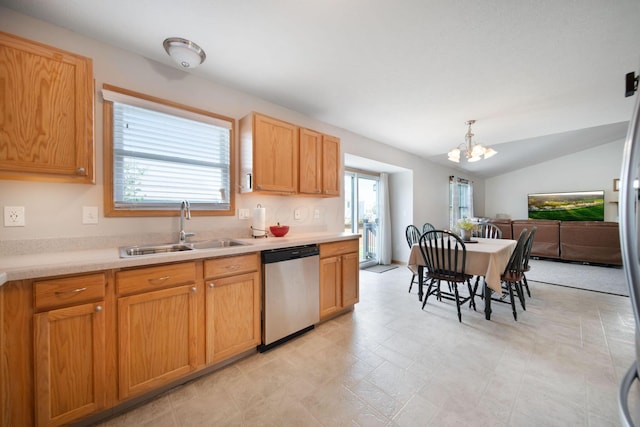 kitchen with an inviting chandelier, light countertops, stainless steel dishwasher, and a sink