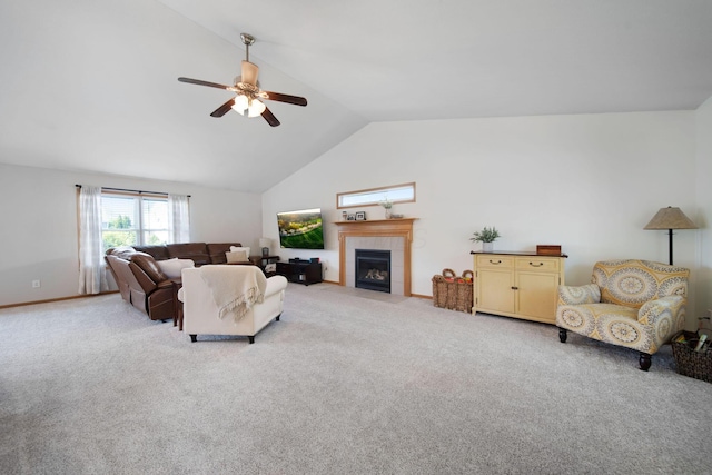 living area featuring a tile fireplace, ceiling fan, light colored carpet, and high vaulted ceiling