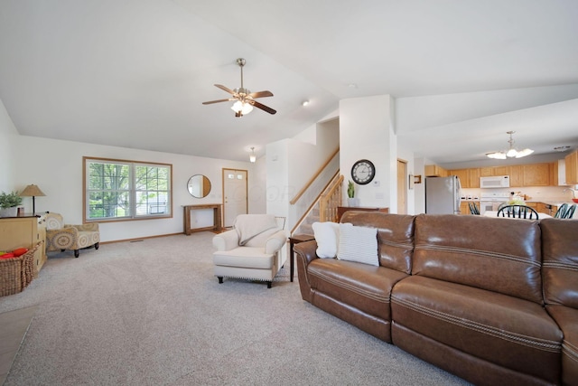 living room with baseboards, ceiling fan with notable chandelier, stairs, vaulted ceiling, and light colored carpet