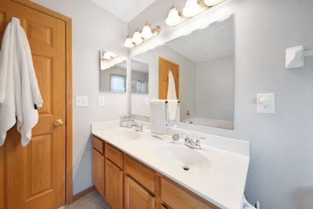 full bath featuring double vanity and a sink
