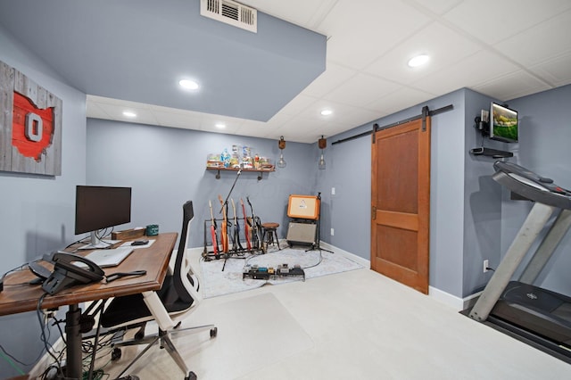 carpeted office with a barn door, visible vents, recessed lighting, a paneled ceiling, and baseboards