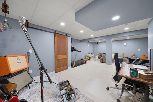 home office with recessed lighting, a barn door, and a paneled ceiling