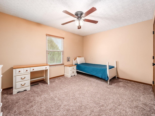 carpeted bedroom featuring a textured ceiling, baseboards, and a ceiling fan