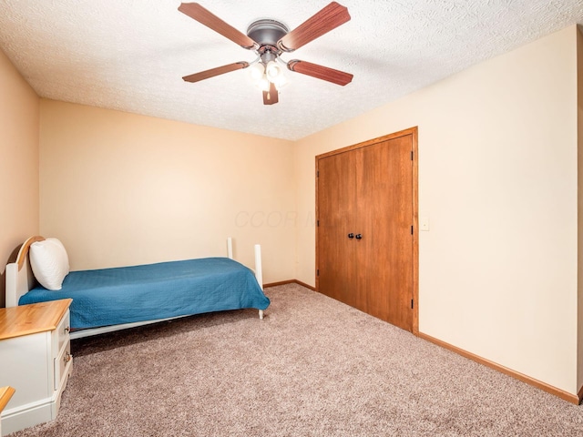 carpeted bedroom featuring a textured ceiling, baseboards, and a ceiling fan