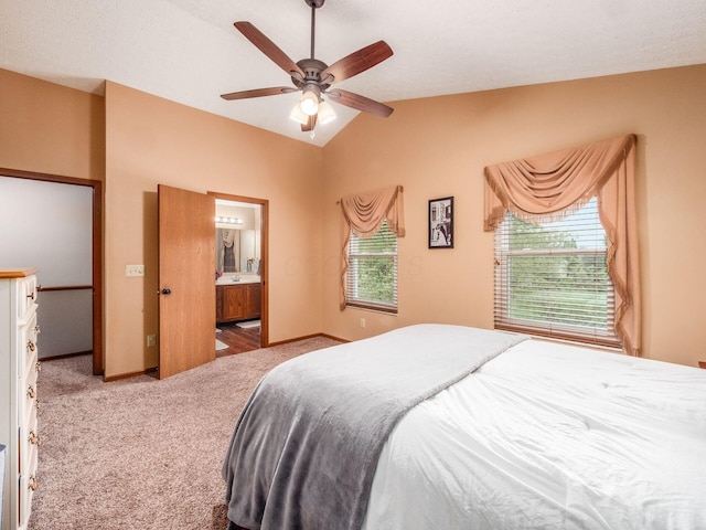 carpeted bedroom featuring lofted ceiling, baseboards, and a ceiling fan