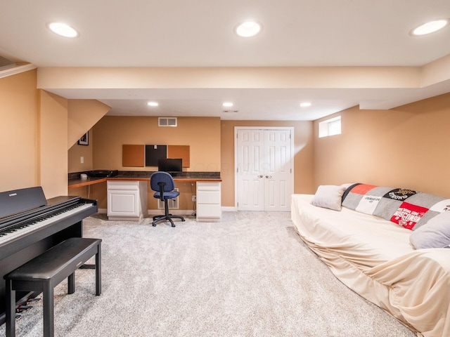 office area featuring recessed lighting, built in study area, visible vents, and light colored carpet