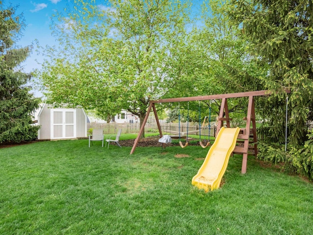 view of jungle gym featuring a fenced backyard, an outdoor structure, a shed, and a lawn