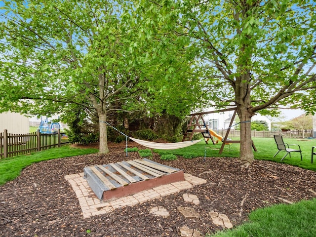 exterior space with a playground, a yard, and fence