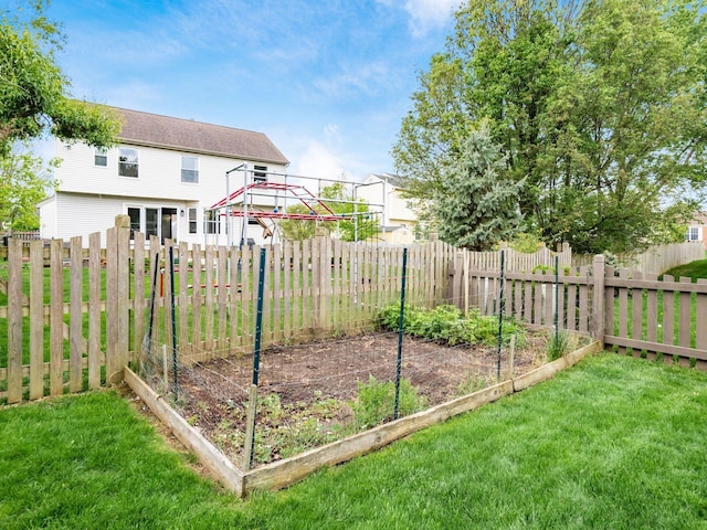 view of yard featuring a vegetable garden and fence