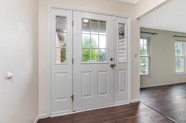 doorway to outside with dark wood-type flooring and baseboards