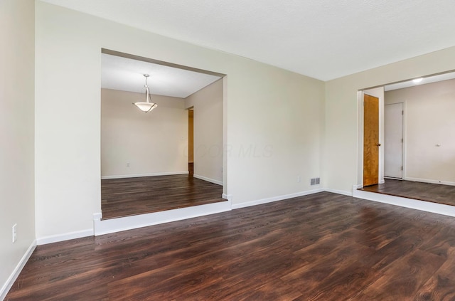 unfurnished room with wood finished floors and baseboards