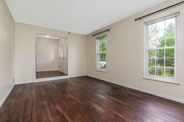 unfurnished room with wood finished floors and baseboards