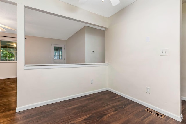 unfurnished room featuring a ceiling fan, wood finished floors, baseboards, and vaulted ceiling