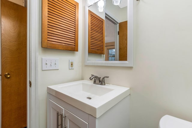 half bath with vanity and toilet