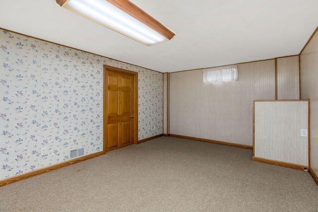 carpeted spare room with wallpapered walls