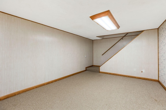 finished basement with carpet flooring, wallpapered walls, and baseboards