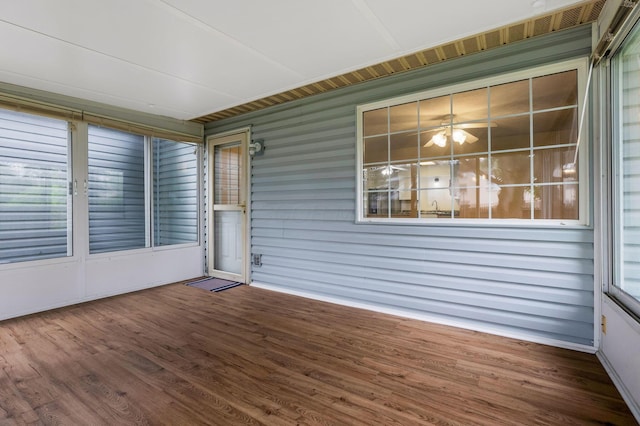 unfurnished sunroom with a ceiling fan
