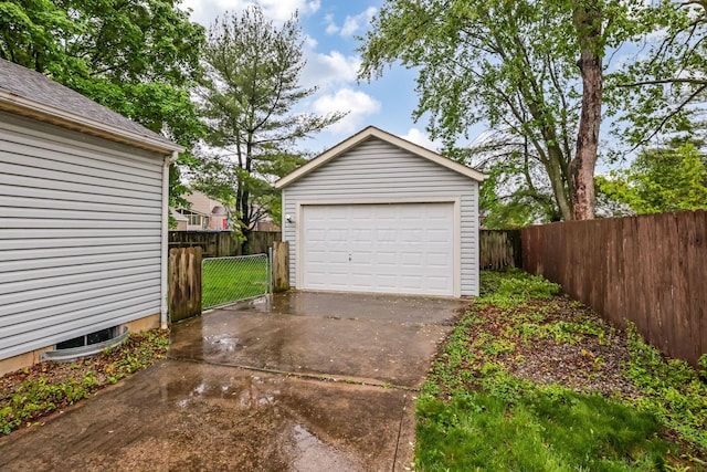 detached garage featuring fence